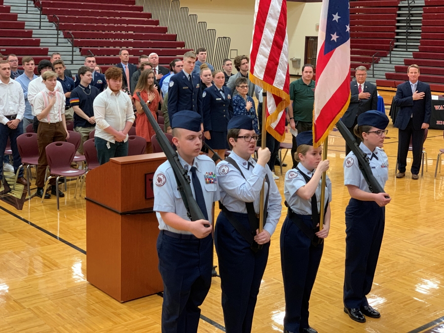 four armed salute with flags